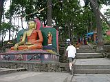 Kathmandu Swayambhunath 09 Buddha Statue Flanks Steps At Back Entrance 